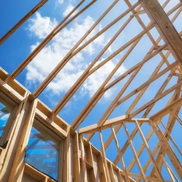 A wooden structure under construction with blue sky in the background.