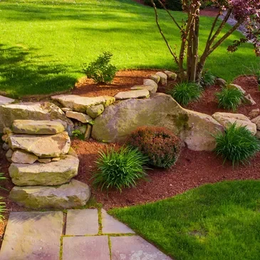 A garden with rocks and grass in the middle of it