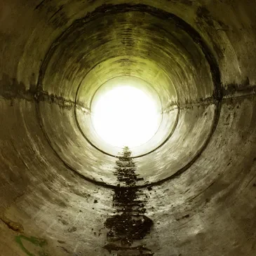 A light shining in the middle of a tunnel.